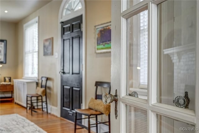 sitting room with radiator and wood finished floors