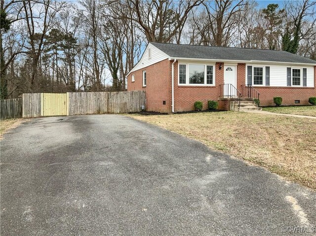 605 Conley Rd, Richmond, VA 23227 - ranch-style house with brick siding, fence, driveway, crawl space, and a front lawn