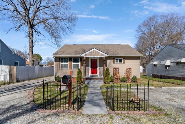 bungalow-style house with a fenced front yard