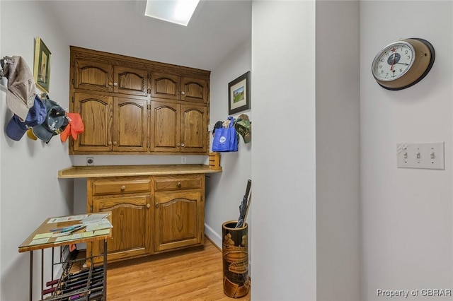 interior space with light wood-style floors and baseboards