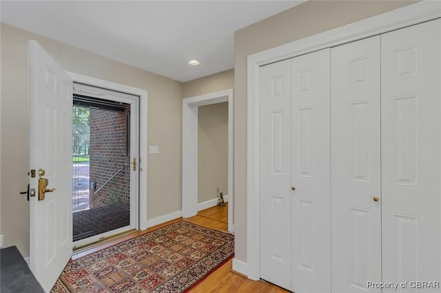 foyer featuring recessed lighting, baseboards, and light wood finished floors