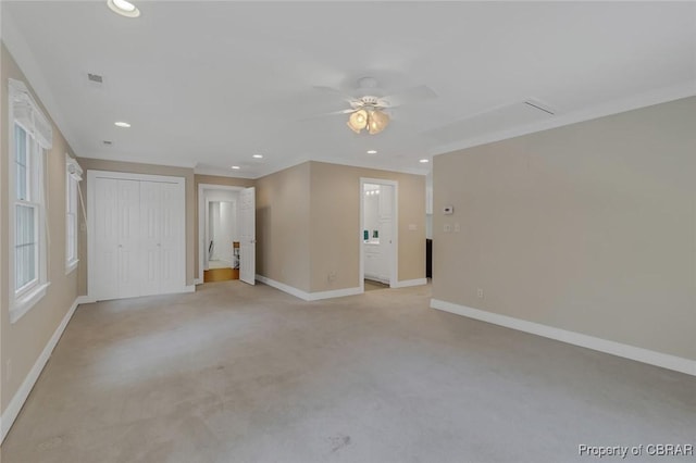 interior space with recessed lighting, light carpet, a ceiling fan, baseboards, and crown molding