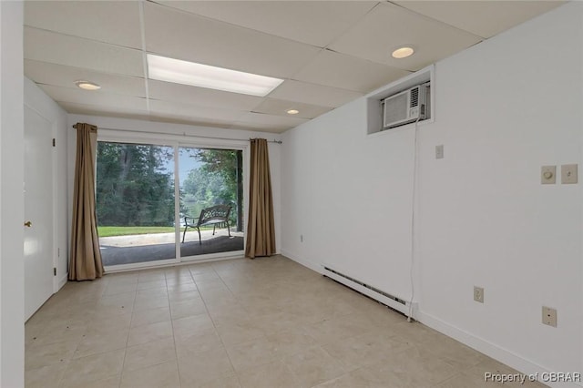 empty room featuring a baseboard radiator, recessed lighting, a paneled ceiling, a wall mounted AC, and baseboards