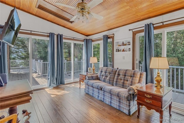 sunroom / solarium featuring vaulted ceiling, ceiling fan, and wood ceiling