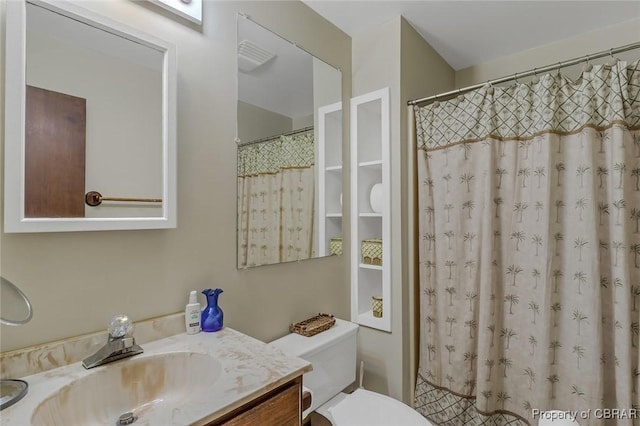 full bathroom with toilet and vanity