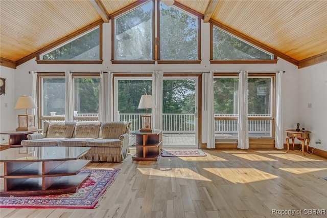 unfurnished sunroom featuring lofted ceiling and wooden ceiling