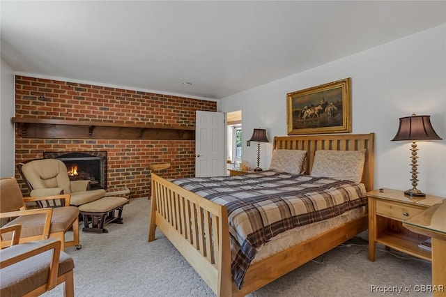 carpeted bedroom with brick wall and a fireplace