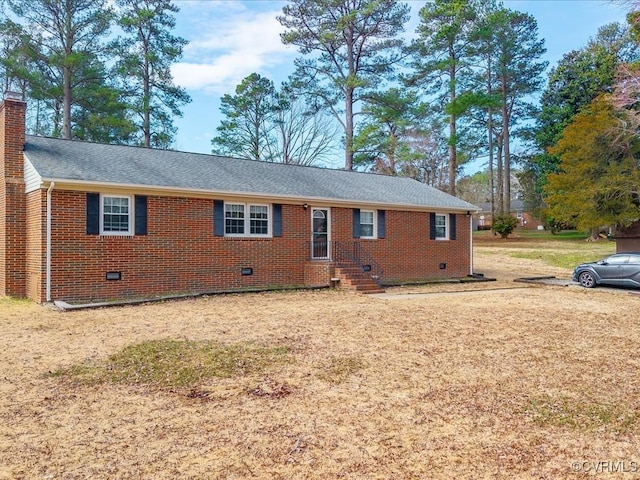 ranch-style home featuring crawl space, brick siding, and a chimney