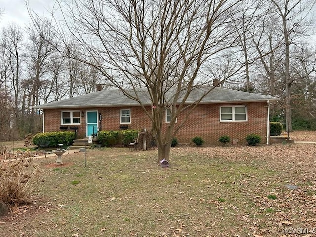 single story home featuring brick siding