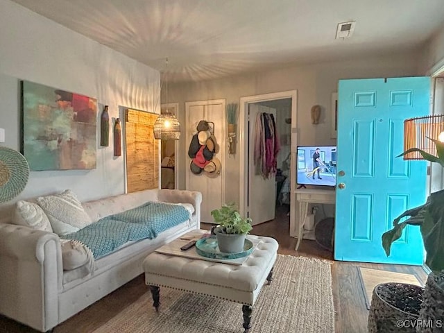 bedroom featuring visible vents and wood finished floors