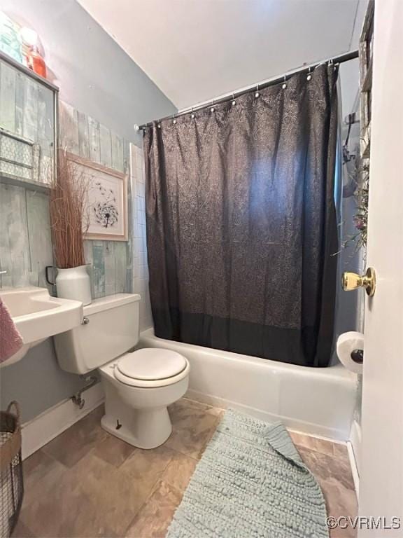 full bathroom with toilet and shower / bath combo with shower curtain