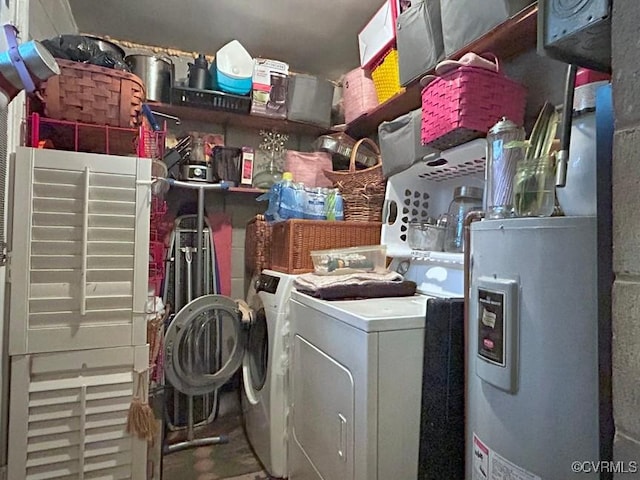 laundry area featuring laundry area, electric water heater, and separate washer and dryer