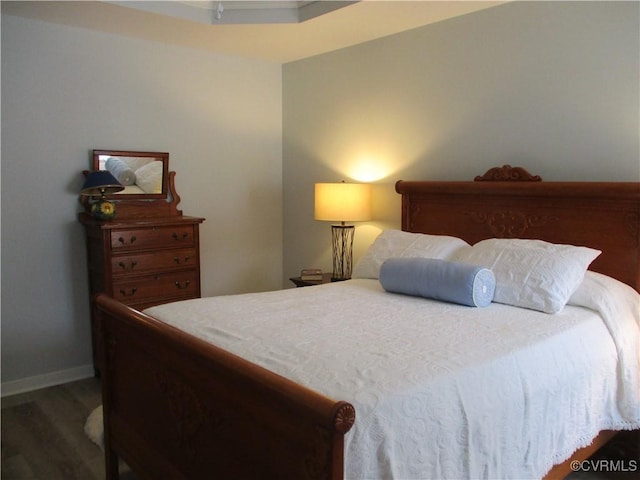 bedroom with wood finished floors and baseboards