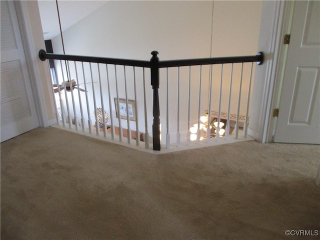 hallway featuring carpet floors and vaulted ceiling