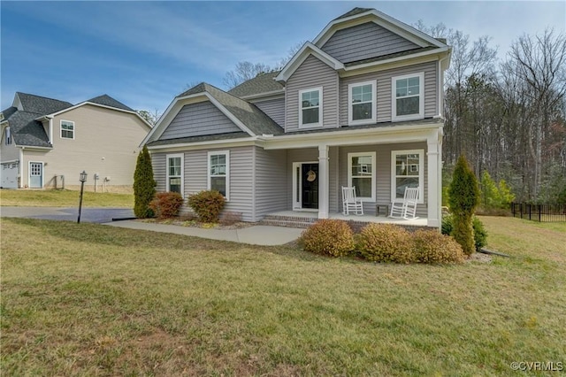 craftsman-style home featuring covered porch and a front yard