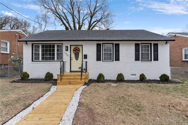 bungalow with brick siding, roof with shingles, crawl space, fence, and a front lawn