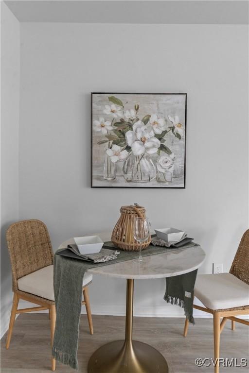 dining area with wood finished floors