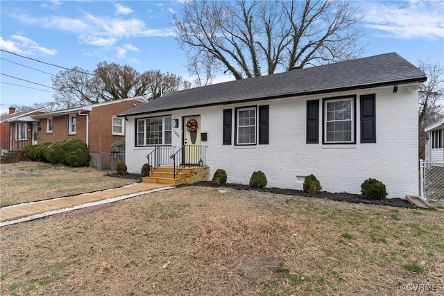 single story home featuring a shingled roof, crawl space, fence, a front lawn, and brick siding