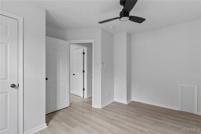 unfurnished bedroom with light wood-style floors, baseboards, and a ceiling fan