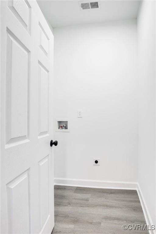 washroom featuring washer hookup, laundry area, visible vents, and wood finished floors