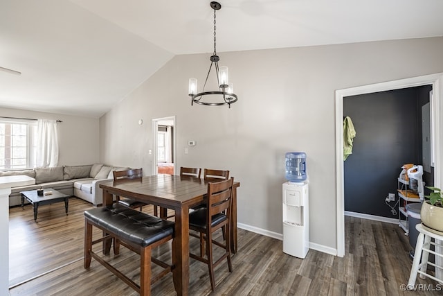 dining room featuring vaulted ceiling, dark wood-type flooring, a chandelier, and baseboards