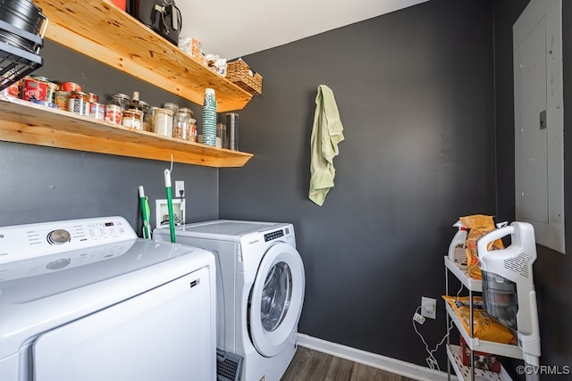 washroom with washing machine and dryer, laundry area, baseboards, and wood finished floors