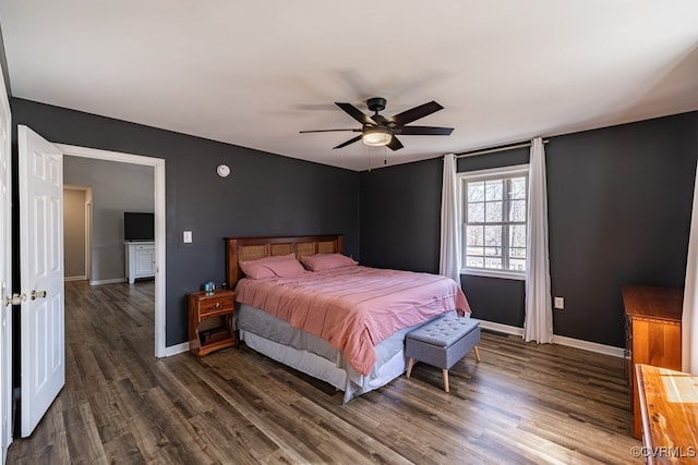 bedroom with ceiling fan, baseboards, and dark wood-type flooring