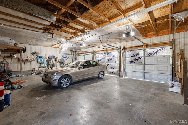 garage with metal wall and a garage door opener