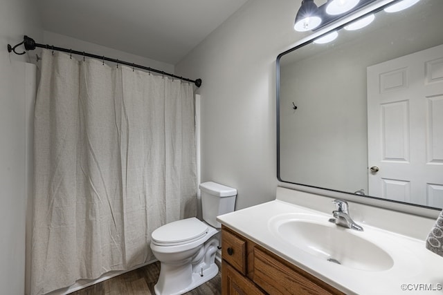 full bath with wood finished floors, vanity, and toilet