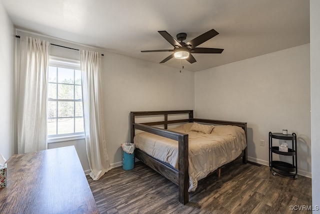 bedroom with ceiling fan, baseboards, and dark wood-type flooring