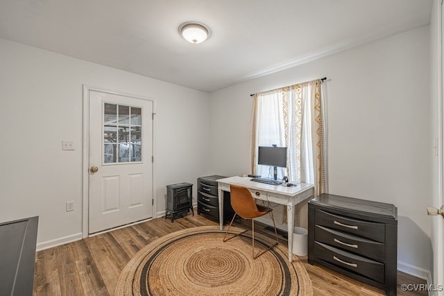 home office with baseboards and wood finished floors