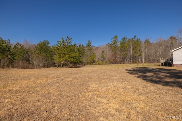 view of yard with a view of trees