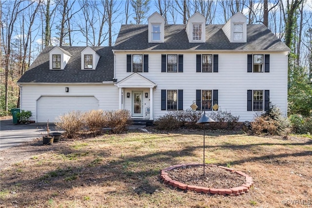 view of front facade featuring a garage, a shingled roof, driveway, and a front lawn