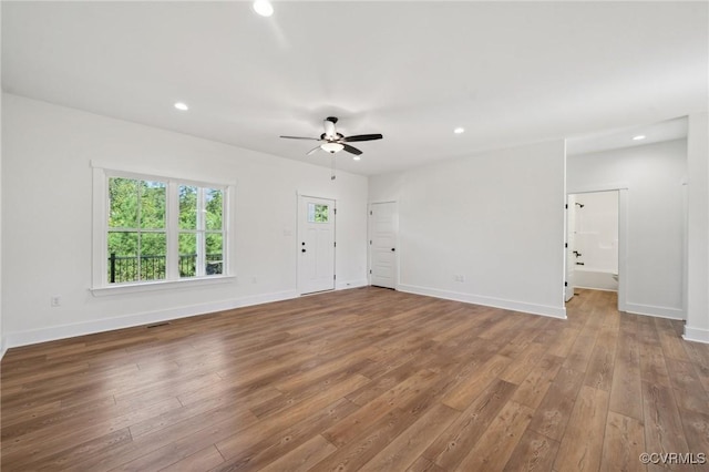 unfurnished living room featuring recessed lighting, ceiling fan, baseboards, and wood finished floors