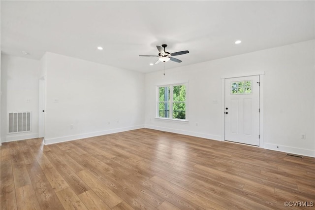 unfurnished living room with recessed lighting, light wood-style floors, visible vents, and baseboards