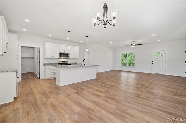 kitchen with recessed lighting, light wood-style floors, appliances with stainless steel finishes, and white cabinets