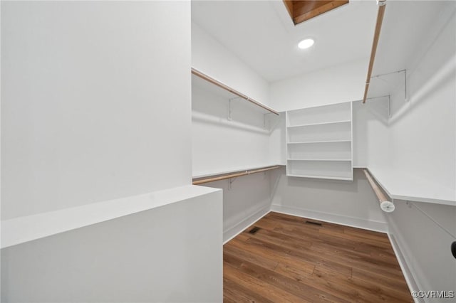 spacious closet with visible vents and dark wood finished floors