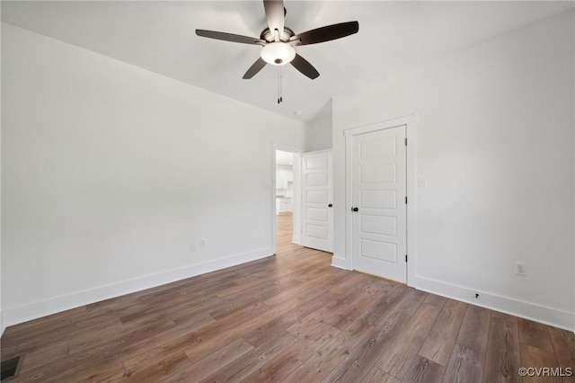 unfurnished bedroom featuring visible vents, a ceiling fan, baseboards, and wood finished floors