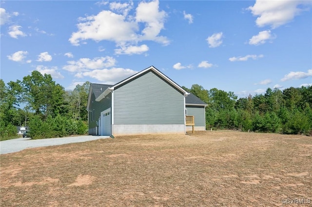 view of home's exterior featuring a garage and driveway