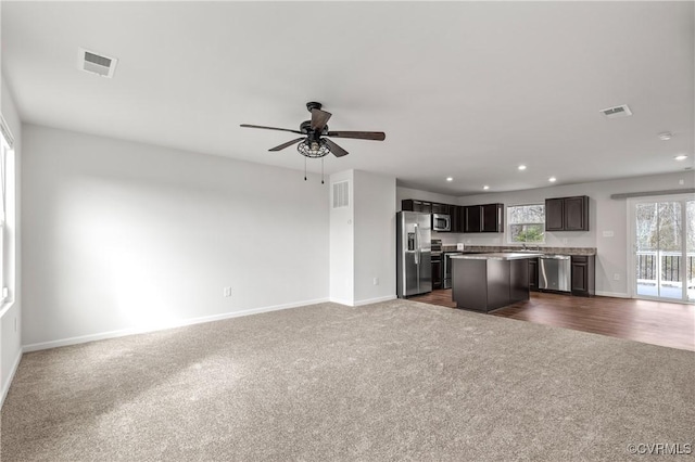 kitchen featuring visible vents, open floor plan, dark colored carpet, and stainless steel appliances