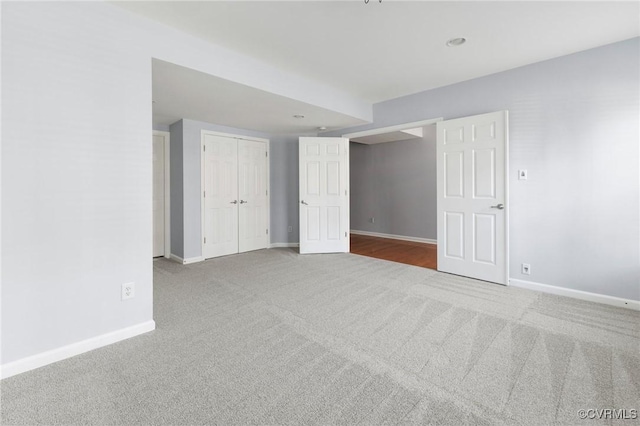 unfurnished room featuring baseboards and carpet floors