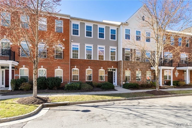 townhome / multi-family property with brick siding