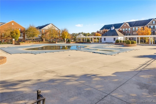 community pool with a patio area