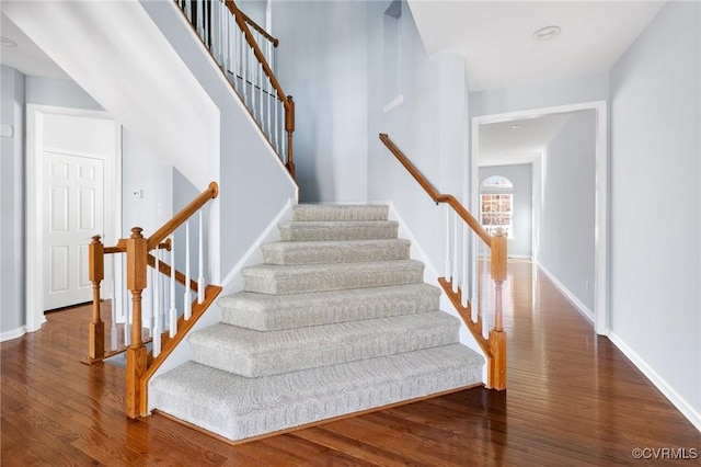 stairs featuring baseboards and wood finished floors