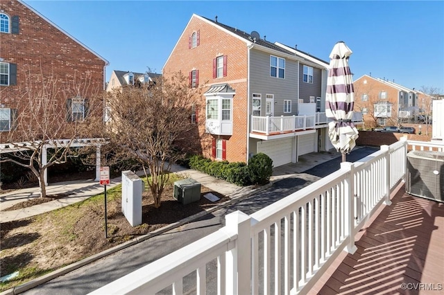 balcony with a residential view and central AC unit