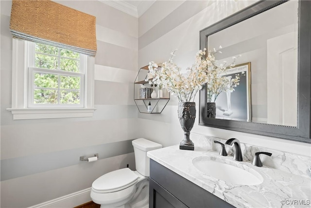 bathroom featuring vanity, crown molding, and toilet