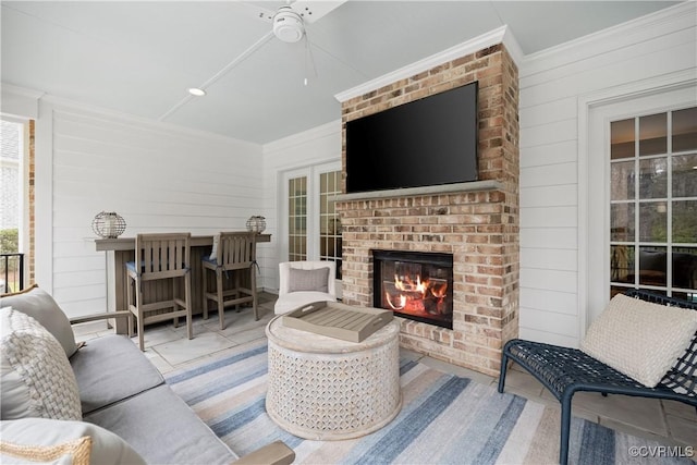 interior space featuring an outdoor living space with a fireplace and a ceiling fan