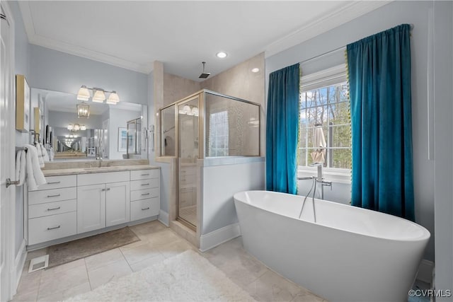 full bathroom featuring vanity, crown molding, a stall shower, and a freestanding bath