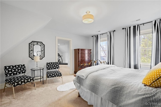 carpeted bedroom featuring visible vents