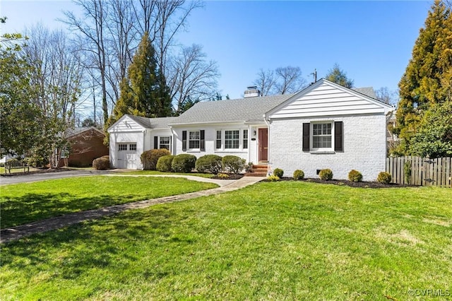 ranch-style house featuring brick siding, a front lawn, fence, aphalt driveway, and a garage